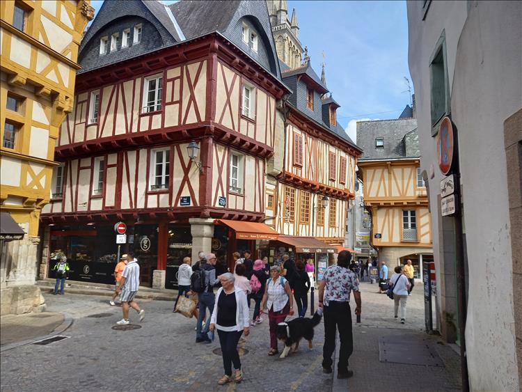 An old timber framed building with the wood painted red in the centre of Vannes