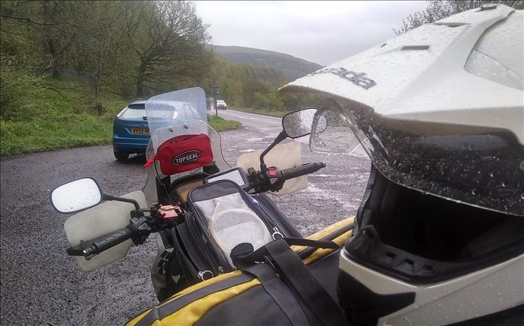 The helmet and the bike are soaking wet by the side of Ladybower Reservoir