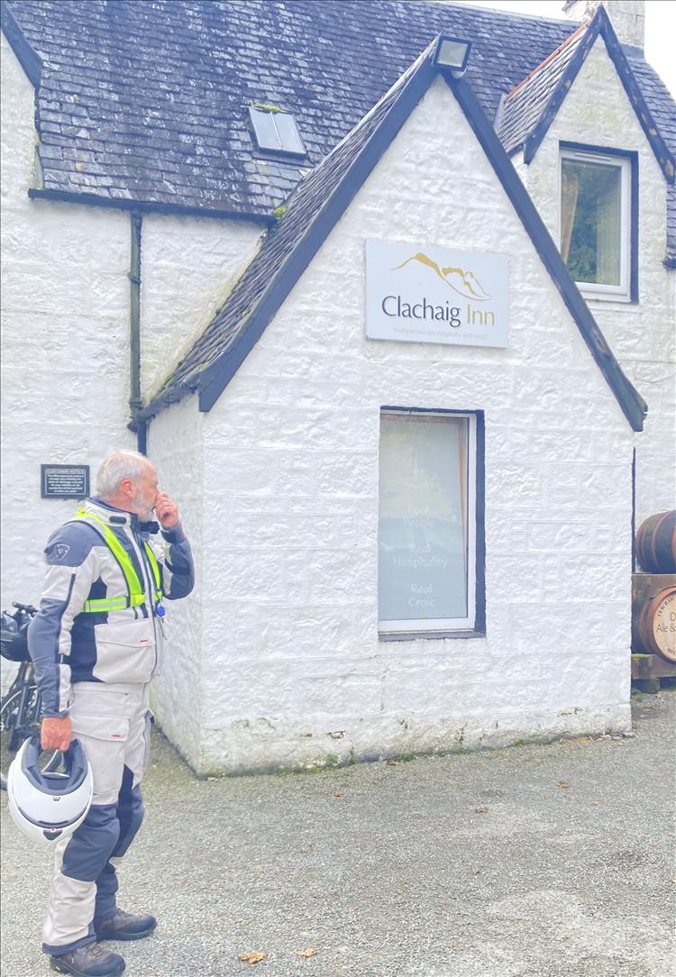 Mick's friend stands in his bike gear outside the door of The Clachaig inn