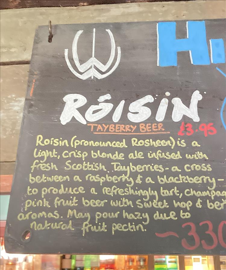 A sign informs us of the Roisin beer inside a pub