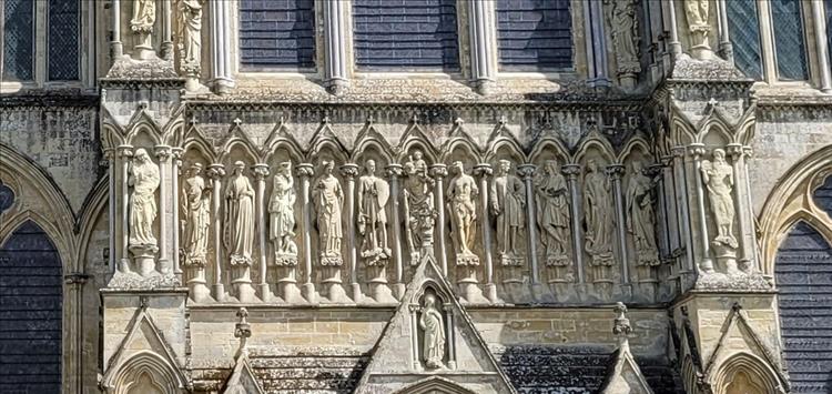 Large, complex and ornate carved stone figures on the walls of Salisbury Cathedral