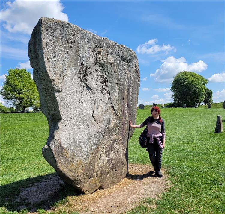 Sharon leans against a massive standing stone at Avebury