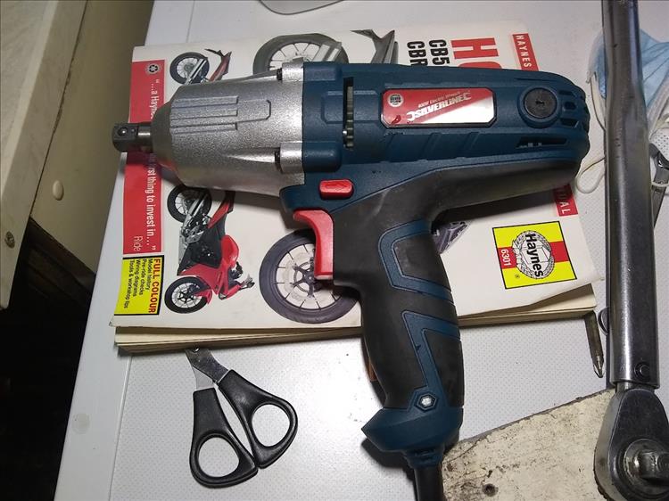 What looks like an electric drill but has a 1/2 inch drive, it's an impact wrench