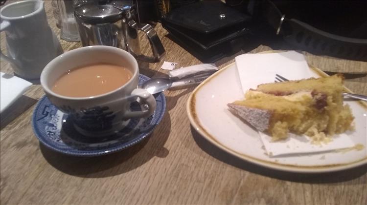 A cup of tea and a victoria sponge cake on the table at the cafe in Inverary