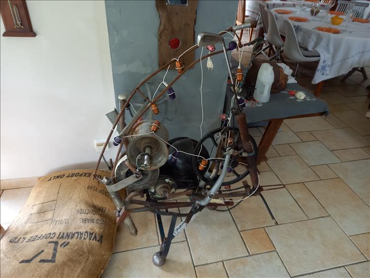 A strange contraption made from metal and string and bobbins and wheels