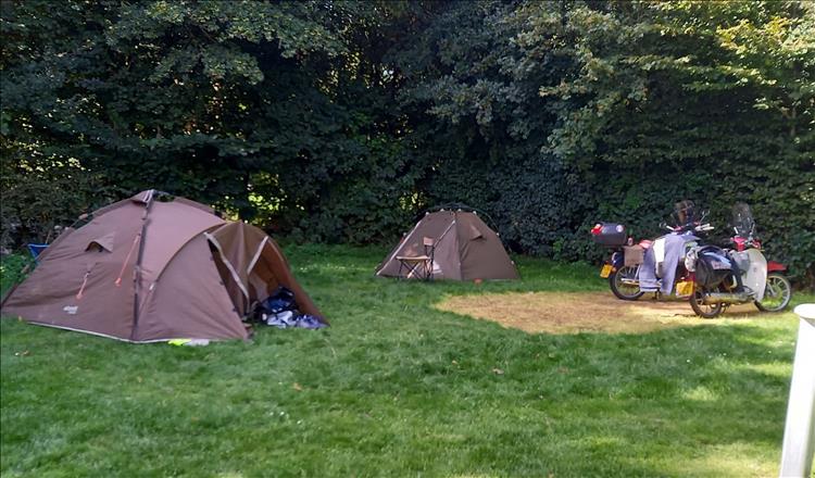 2 tent and 2 Cub 125s at the campsite in Ypres among the trees