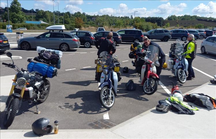 3 C125 cubs and a fantic cabellero on a car park somewhere near the Alps in France