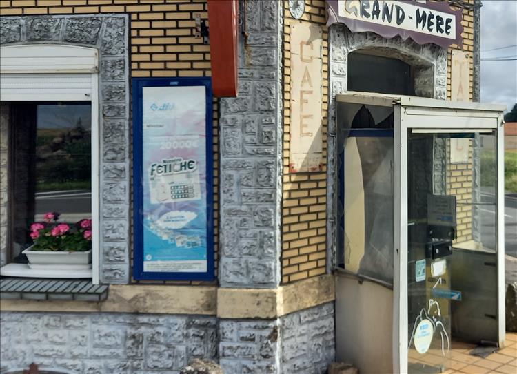 Worn out signs and scruffy brickwork of the cafe