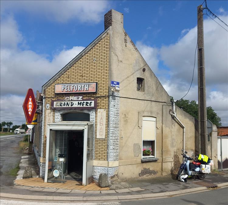 The cafe on the street corner with ancient signs and looking very tired