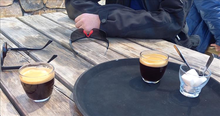 A table with coffees and sunglasses