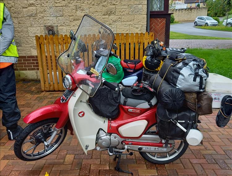 A red C125 ram packed with luggage