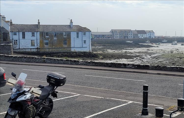 Houses and sea wall at Isle of Whithorn and the CB500X on the car park