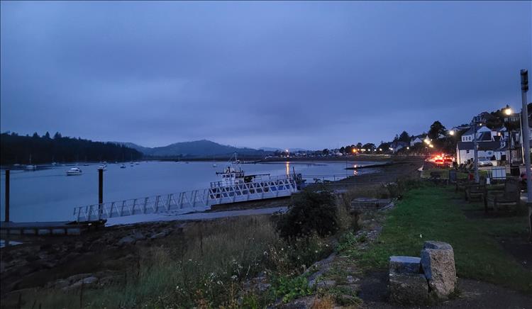 The estuary, with the town in the encroaching darkness and heavy skies