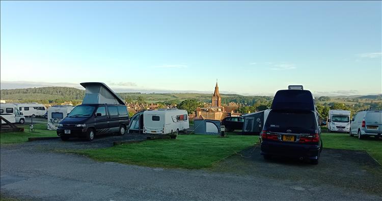 From over the tents and campers we see the church and town of Kirkcudbright as the sun rises