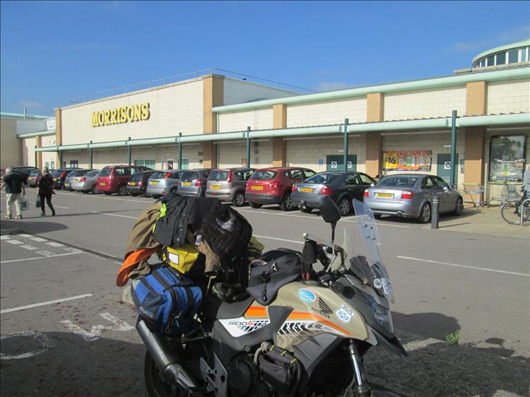 Ren's bike fully loaded outside a supermarket while travelling