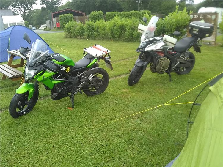 The bikes unloaded and wet in the rain at the campsite in Devon