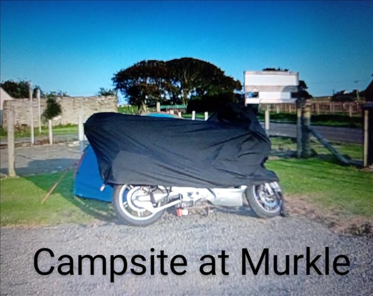 RODs bike is covered and parked next to his tiny blue tent at the campsite in Murkle