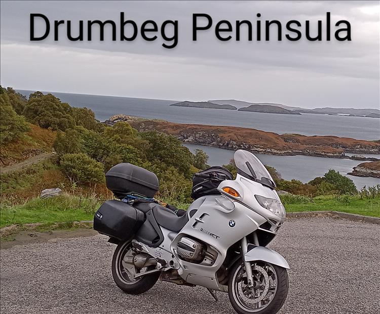 The Beemer again with the sea and islands and wonderful Highland views
