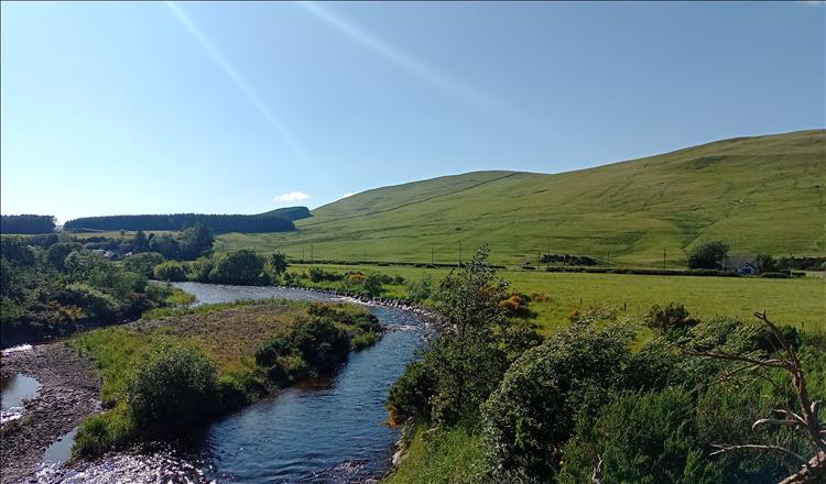 Gentle slops and hills, babbling brook and soft scenery in the borders