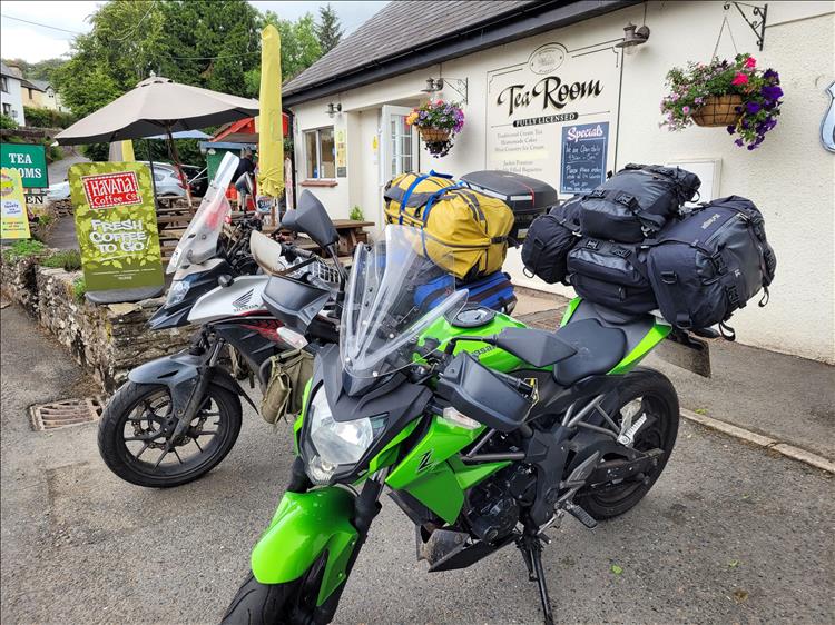 The motorcycles with camping kit outsite a cute tea rooms in Devon