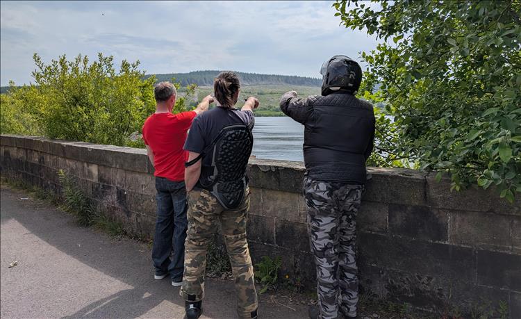 The 3 lads looking away, all pointing across the reservoir, looking silly