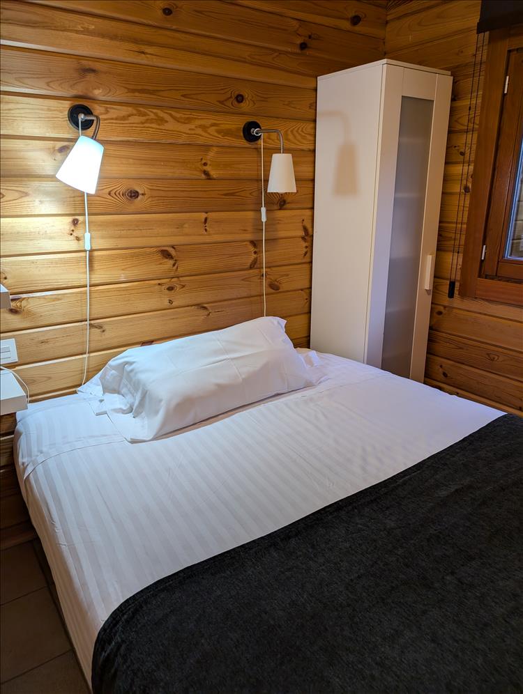 A real bed in the small but nice wooden room of the lodge