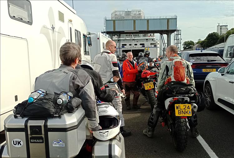  line of bikes and rides hanging out in the sun awaiting boarding the ferry