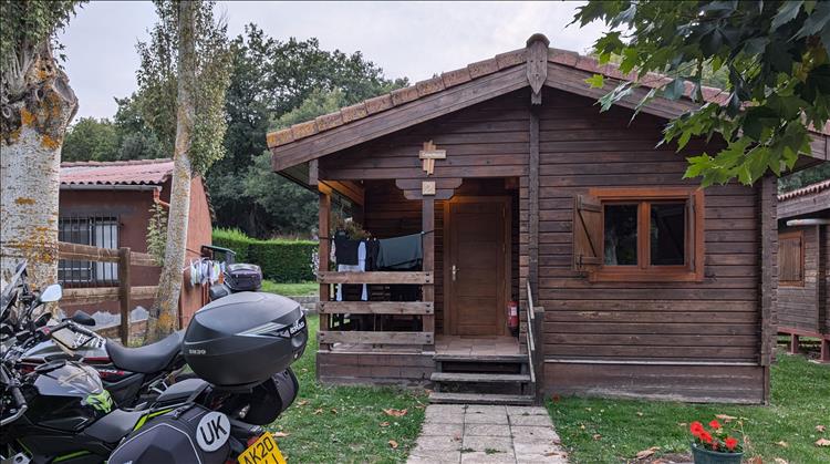 The bikes out front of a timber lodge on the campsite 