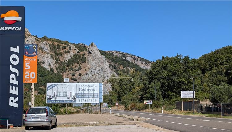 A big Repsol sign against the rugged rocky hillside by the petrol station