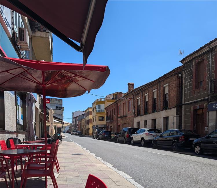 Looking down the street we see simply buildings and a blue sky