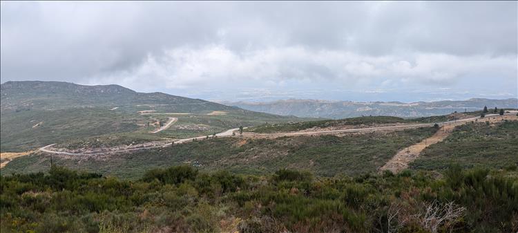 Hardy bushes, wiggly roads, angular hill tops and wasy in the distance flatlands