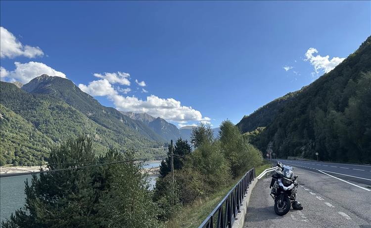 Andy's 1250 parked beside a lake and road and wonderful mountains