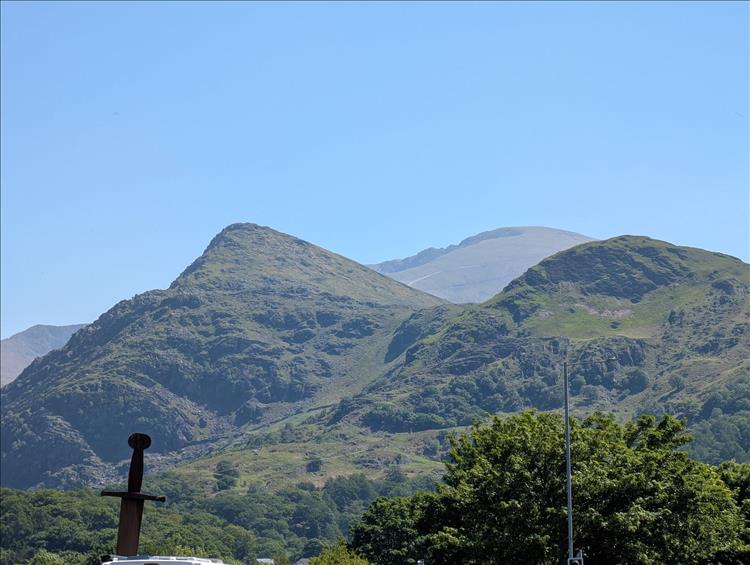 Steep hills and mountains under clear blue skies