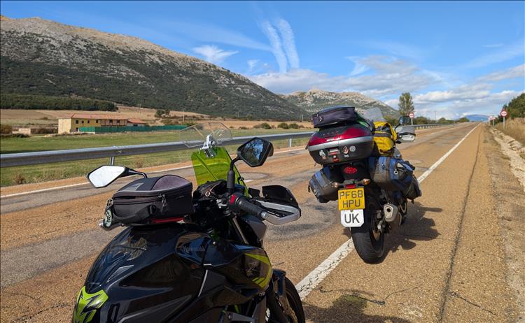 The 2 bikes, a long straight road and rolling hills coming into The Picos from the south