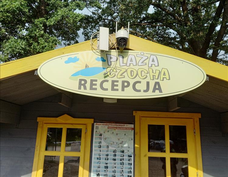 The sign above the small reception hut at the Polish campsite reads Plaza Czoch Recepcja