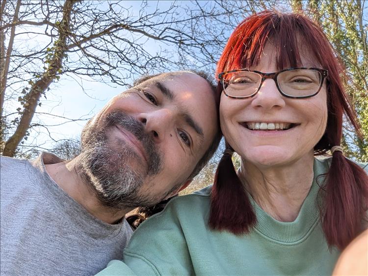 Ren and Sharon in close up smiling into the camera on a lovely day
