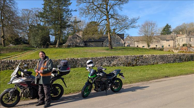 Ren and the motorcycles in the glorious sun with Tissington Hall in the background