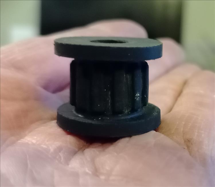 A small rubber item that looks like a small cotton reel in shape with a hole through it