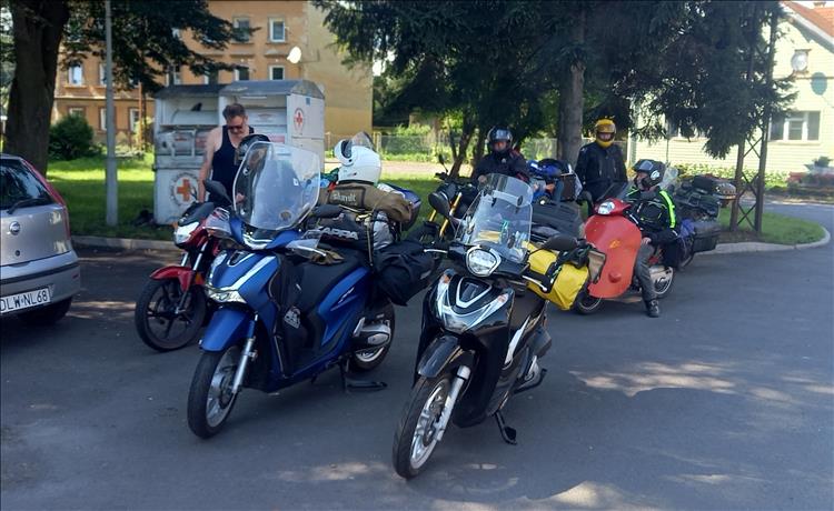 The motley collection of small capacity motorcycles and riders in Poland by the roadside