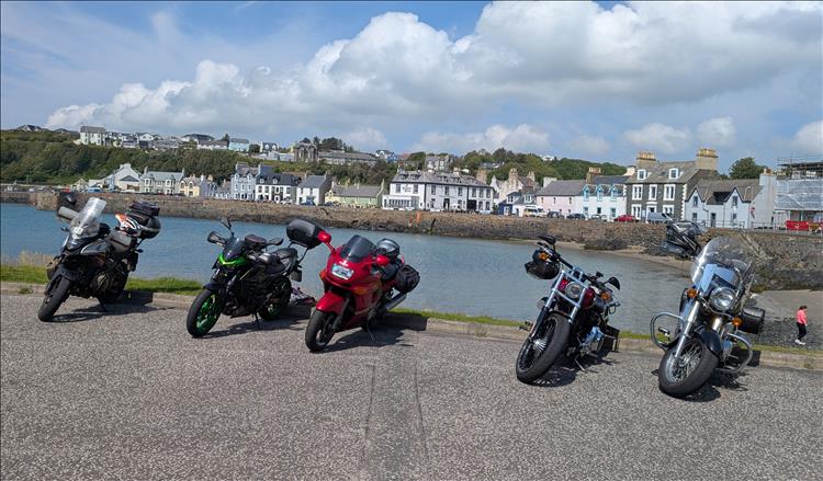 5 varied motorcycle by the curved sea and shoreline building at Port Patrick