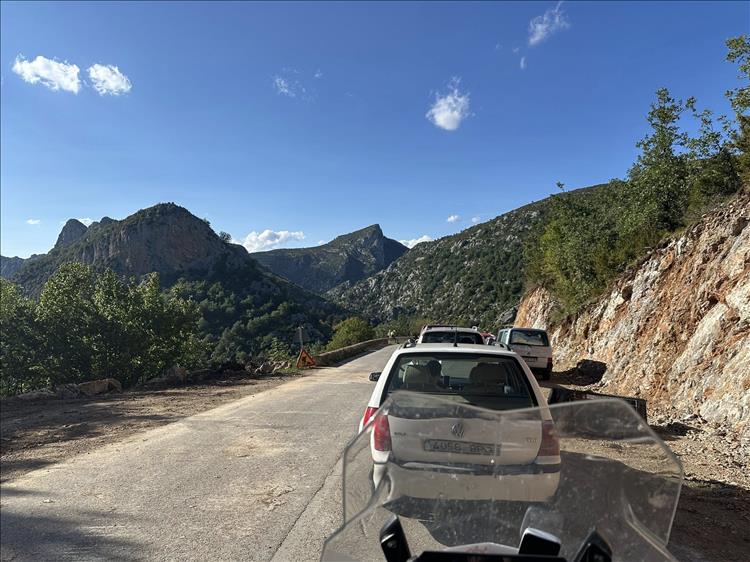 blue skies, alas cars and a blocked road among the amazing mountains and rocks
