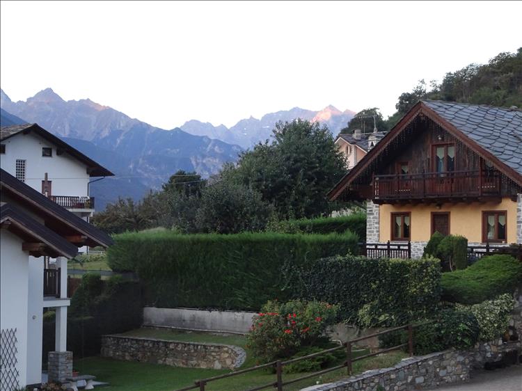 Jagged mountain peaks behind Alpine style houses and chalets