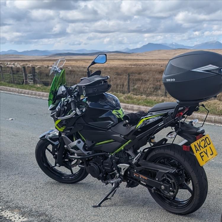 The Z400 with touring kit on a wild welsh mountain road