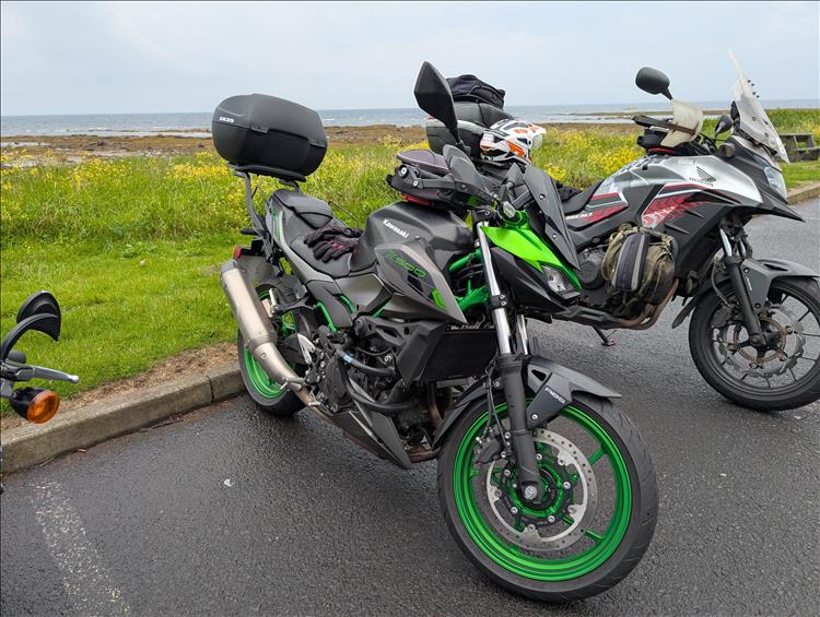 The Z500 and CB500X beside the coast with just mist covereing the waters near Ayr