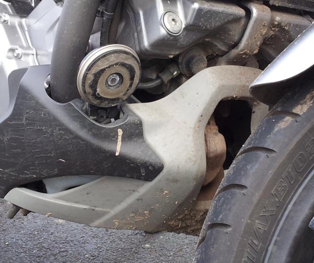 A horn on a motorcycle covered in dirt