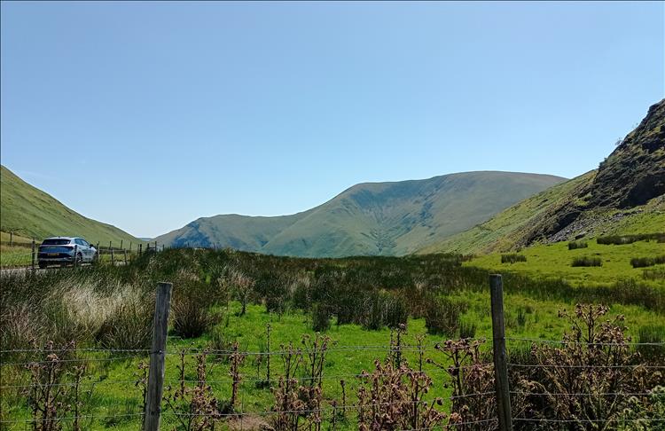 Steep welsh mountians and hardy moorland under clear blue skies