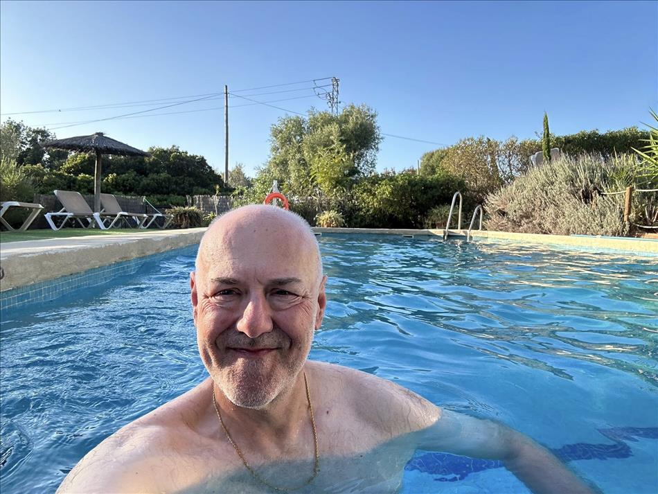 Andy in a pool, a few deck chairs and a lot of plants around too
