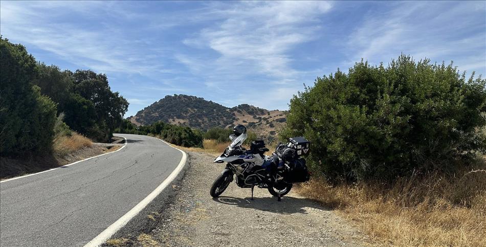 Andy's BMW in the spanish scenery, trees, grass, the narrow lane and blue skies