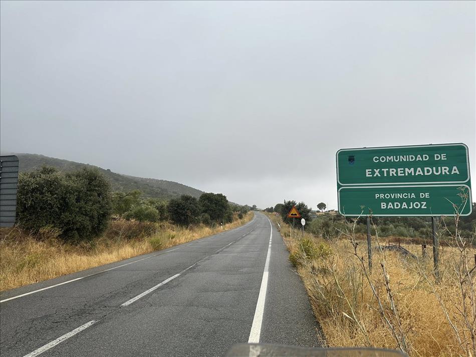 A wet road and green Spanish signs for Badajoz and Extremadura