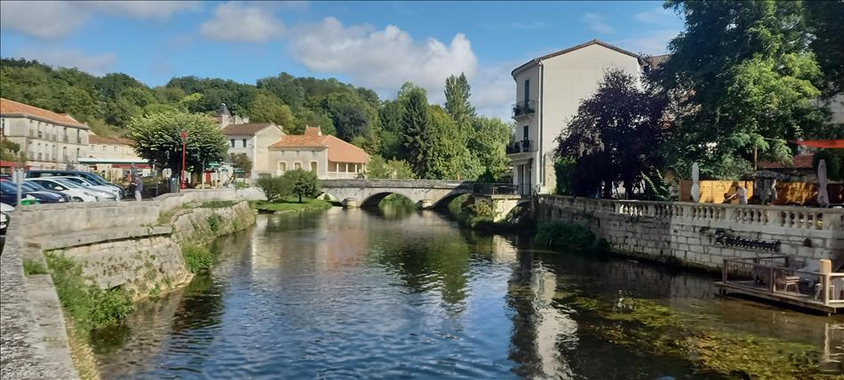 Looking the other way we see shops and houses by the calm river